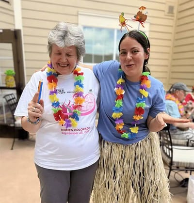 Residents and staff celebrating in Hawaiian-themed attire