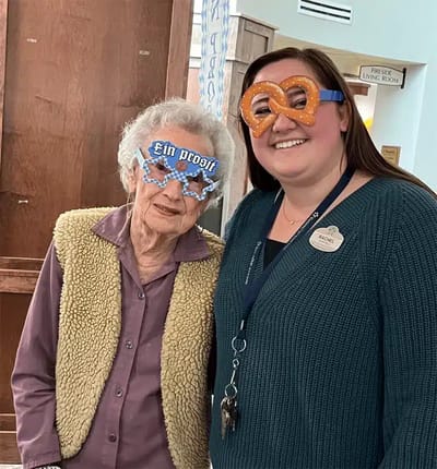 Resident and staff member celebrating together