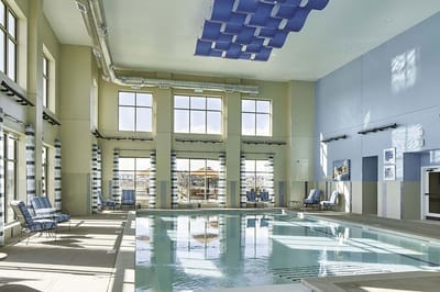 Indoor swimming pool area with seating