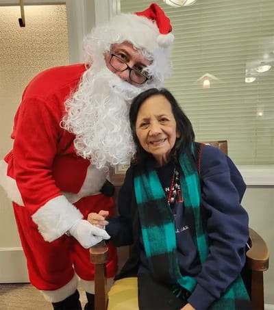 Resident with Santa during a holiday celebration