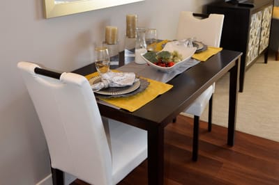 Cozy dining setup with table and chairs.
