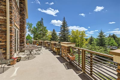 Outdoor patio area with tables and trees