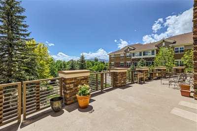 Outdoor terrace with seating and vibrant landscaping