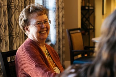 A smiling resident in a common area