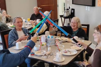 Residents enjoying a lively mealtime activity