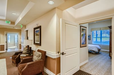 Common area with seating and open doorway to a bedroom