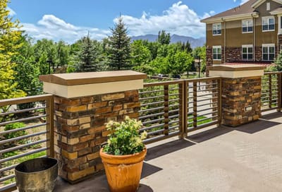 Outdoor patio area with planters and greenery