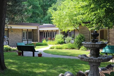 Serene outdoor garden area with a fountain and pathways