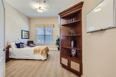 Cozy resident room with a bed and bookshelf