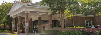 Exterior view of Paul Spring Community with residents outside