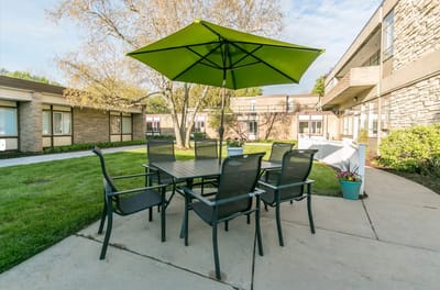 Outdoor seating area with green umbrella