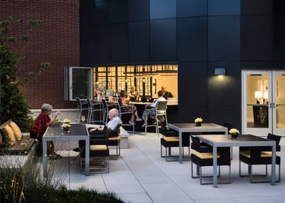 Residents enjoying the outdoor seating area of the facility