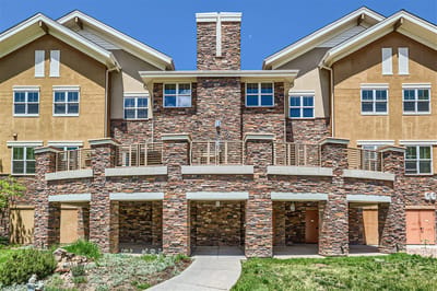 Exterior view of a senior living facility with a stone facade