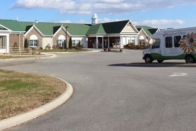 Exterior view of Meadow View Senior Living with shuttle