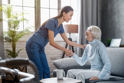 A caregiver and resident sharing a moment in a common area