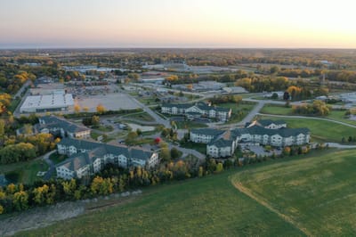 Aerial view of a senior living facility with surrounding landscape