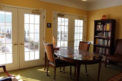 Bright common area with a puzzle table and bookshelves