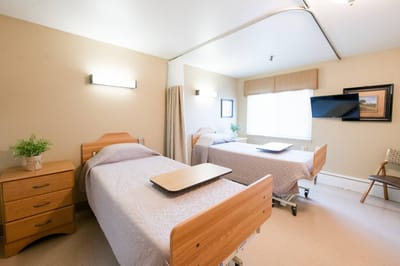 Two private resident rooms with beds and furnishings