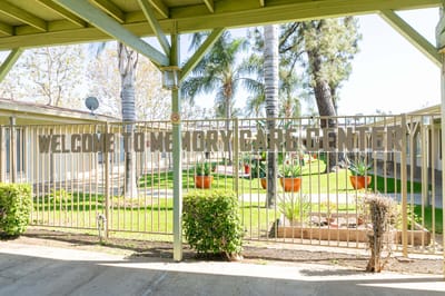 Welcome gate of a memory care center in a garden setting