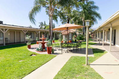 Outdoor seating area with fountain and gardens