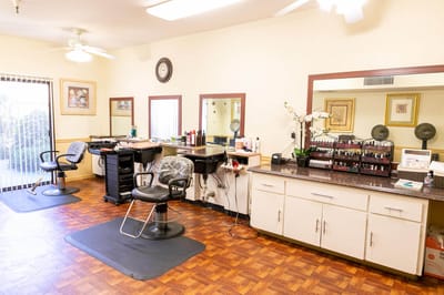 Hair salon area with styling chairs and mirrors