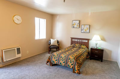 Cozy resident room with bed and seating area