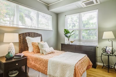 Cozy resident bedroom with warm decor and natural light