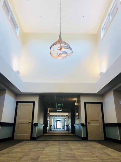 Spacious interior hallway with light fixtures