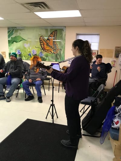 Musician performing for residents in common room