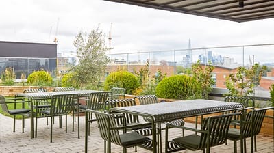 Outdoor seating area with plants and tables