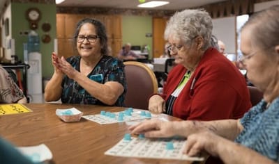 Residents enjoying a bingo game in a common area.
