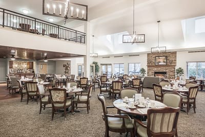 Dining area with tables and chairs in a bright interior.