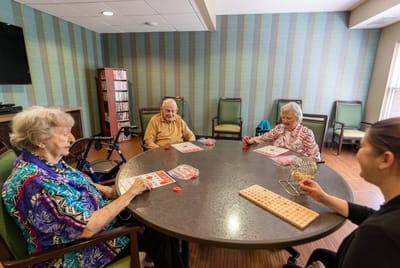 Seniors playing bingo in a common area