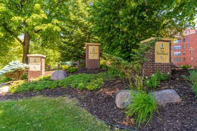 Landscaped entrance with signage at The Glenn Hopkins