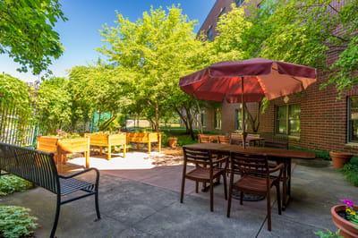Outdoor patio area with seating and landscaping.