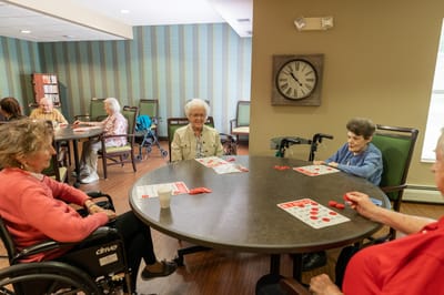 Residents engaging in a game activity in a common area.