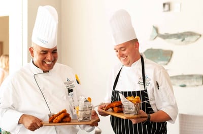 Chefs presenting food in a dining setting