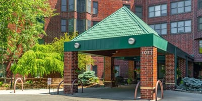 Entryway of a senior living facility with green roofing