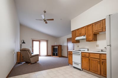 Cozy studio apartment with a kitchenette and seating area.