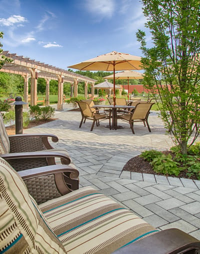 Outdoor seating area with umbrellas and landscaping