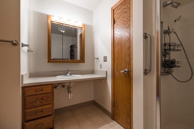 Private bathroom with a sink and shower area.