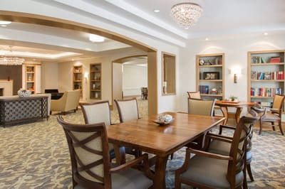 Common area with dining table and bookshelves