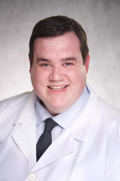 Smiling healthcare professional in a lab coat.
