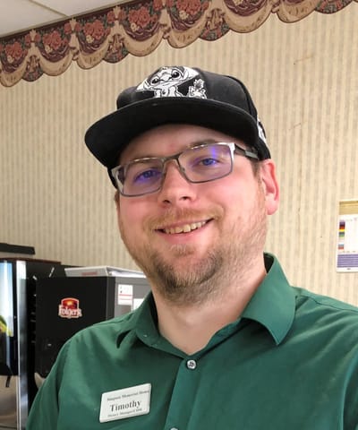 Staff member smiling in facility interior