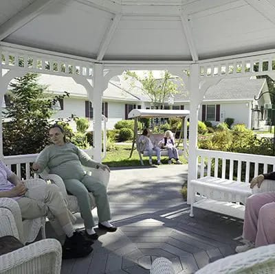 Residents chatting in a gazebo at the facility