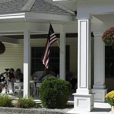 Outdoor seating area with residents socializing.