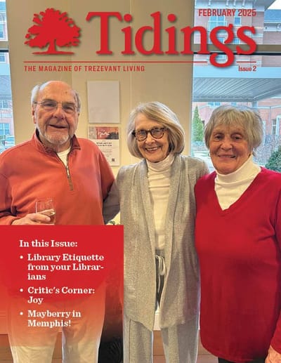 Three residents smiling in a common area.