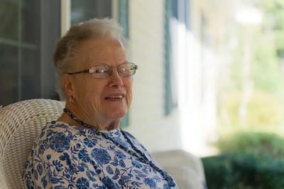 Senior woman enjoying a moment outdoors.