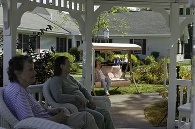 Residents enjoying time on the patio in a gazebo.