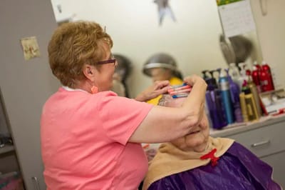 Staff member helping a resident with hair care